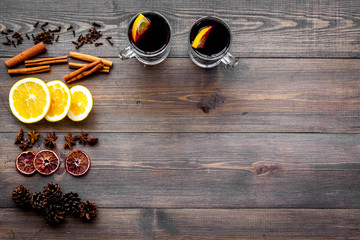Ingredients for mulled wine. Spices cinnamon and badian, citrus fruits on dark wooden background top view copyspace