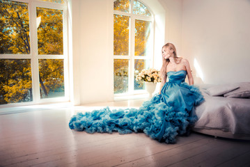 Beautiful woman with fancy wedding dress make preparations for the event