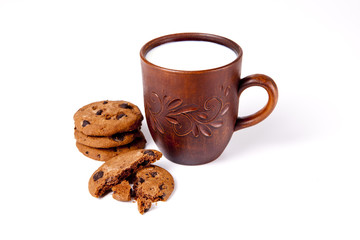 Cup of milk with biscuits on white background.