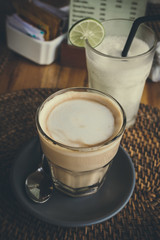 Closeup cup of coffee latte in a tropical restaurant of Bali island, Indonesia.