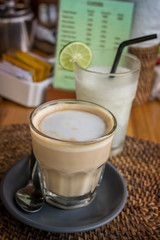 Closeup cup of coffee latte in a tropical restaurant of Bali island, Indonesia.