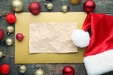 Naklejka na ściany i meble Blank sheet of paper with santa hat and christmas baubles