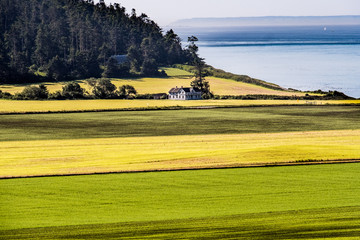 Historic building on prairie overlooking water and misty islands