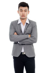 Portrait of a businessman with arms folded. Isolated on white background