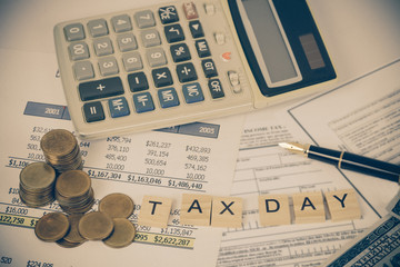 wording tax and calculator with tax documents and money on table. Tax concept.