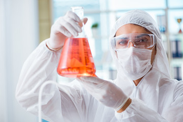 Chemist working in the laboratory with hazardous chemicals