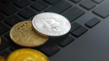 golden and silver bitcoins on keyboard