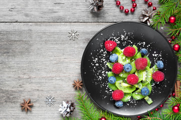 kiwi christmas tree with berries and coconut looks like snow