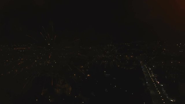 Aerial view Beautiful fireworks video from the drone in the night sky on celebration. Sparks. Fireworks are a class of explosive pyrotechnic devices used for aesthetic and entertainment purposes