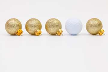 Gold Christmas decoration and white golf ball