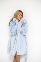 Young beautiful blonde woman in a blue fur coat