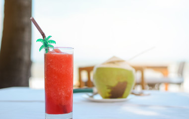 Soft drink on wood table in sea and sky background.