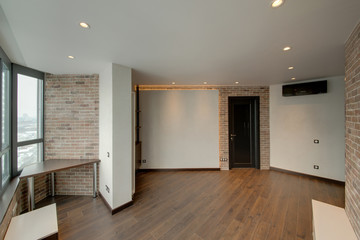 The room combined by a red brick and white walls with dark doors and a dark floor