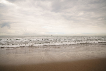 ocean waves on Santa Monica beach in cloudy november day