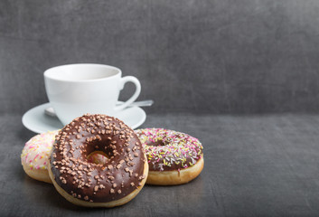 donuts on a grey table with coffee