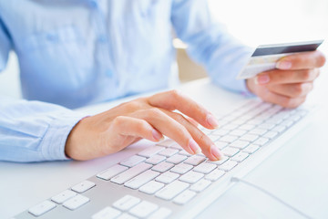 Woman using a credit card for online payments. The concept of online shopping