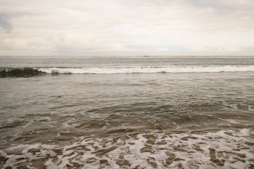 ocean waves on Santa Monica beach in cloudy november day
