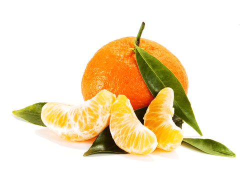 Ripe mandarin with leaves close-up