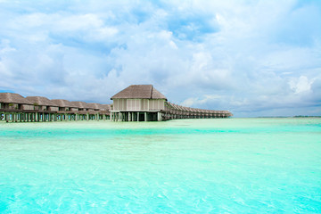 Fototapeta na wymiar Wooden villas over water of the Indian Ocean, Maldives