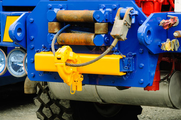 Winch on a towtruck with hook and metal cable.