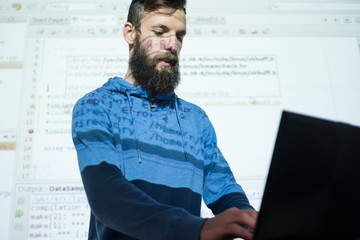 programmer courses at education center. Man looking in laptop while lecturing on information and...