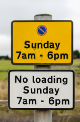 Sign advising motorists that there is no parking in this area on Sundays from 7am to 6pm.