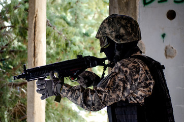 Fototapeta premium Trops wear digital uniform protection mask helmet rifle and vest