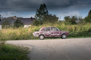 An old car on the asphalt road