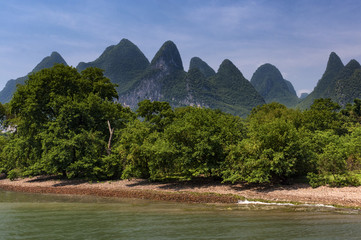 View of the Li River with the tall limestone peaks on the background near Yangshuo, China, Asia; Concept for travel in China