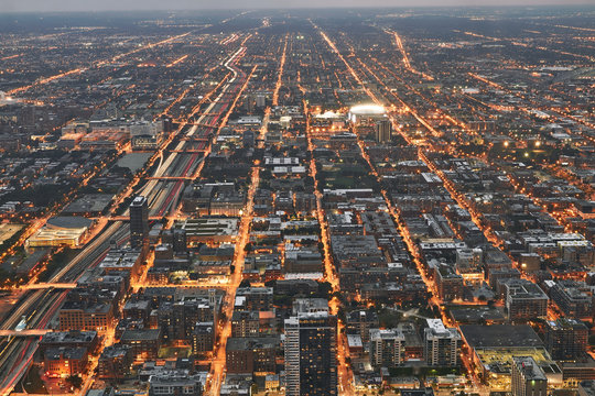 Chicago cityscape during sunset at night. Taken from above at Skydeck Willis Tower. Railroad in sight