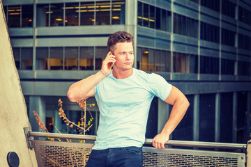 American businessman talking on phone in raining day, grainy, foggy, drizzly background. Wearing...