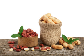 peanuts with leaf in bag on old wooden background