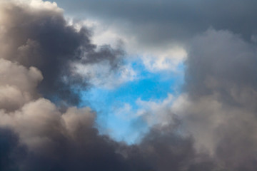 Fototapeta na wymiar Thick black smoke on blue sky background