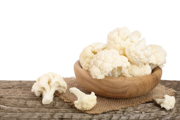 Piece of cauliflower in bowl on wooden table with white background