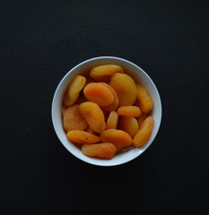 Bright Dried Apricots ib a White Bowl