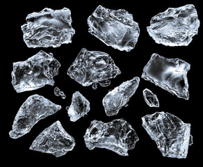 Set of crushed ice cubes on black background, isolated on black. Clipping path for each piece.