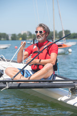senior man on catamaran