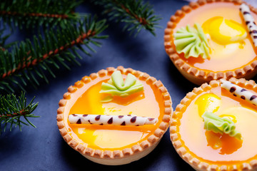 Orange cake basket and fir tree branch 