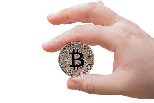 Cryptocurrency bitcoin coin isolated on white with selective focus. Female hand holding symbol of crypto currency - electronic virtual money for web banking and international network payment