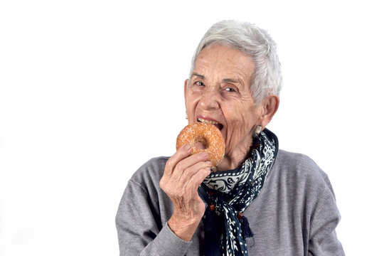 Senior Woman Eating Donut On White