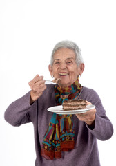 Older woman eating a piece of cake