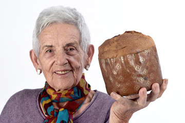Older woman eating panettone on white background