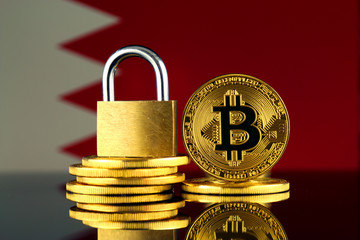 Physical version of Bitcoin, golden padlock and Bahrain Flag. Prohibition of cryptocurrencies,...
