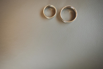 Gold and silver wedding rings on white table