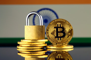 Physical version of Bitcoin, golden padlock and India Flag. Prohibition of cryptocurrencies, regulations, restrictions or security, protection, privacy.