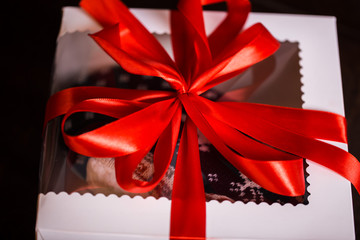 Christmas gifts with red bow and christmas illuminations on a black background