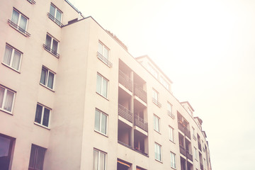 Fototapeta na wymiar white big apartment block in warm sunlight