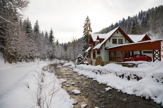Red house and small river in winter farest in mountain