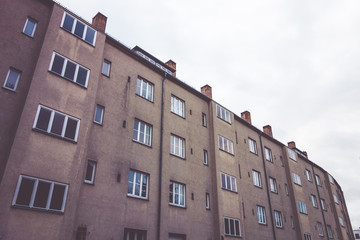 typical gdr building with brown facade on a cloudy day