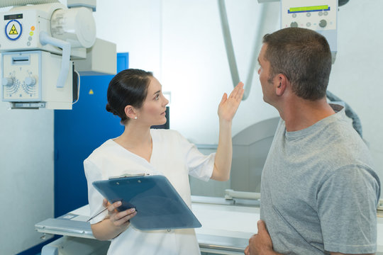 male patient at xray machine with female doctor
